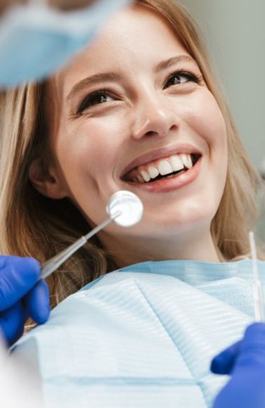 Lady smiles at dentist