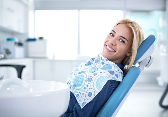 Smiling woman in dentist’s chair