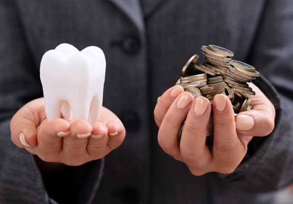 Molar and coins in hands