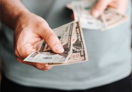 Man holding out cash for payment