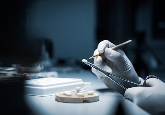 a technician working on a dental crown