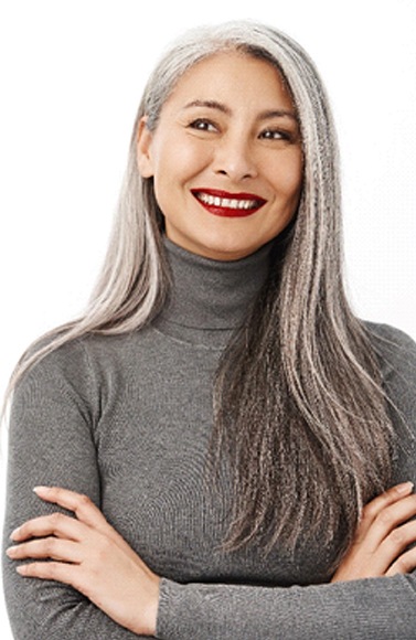 a woman smiling with dentures in Lewisville