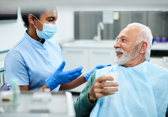 a patient talking to a dentist about dentures in Lewisville