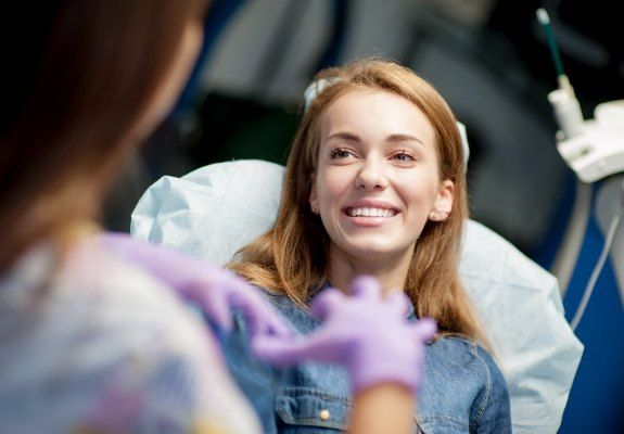 Dental patient and dentist discussing keys to preventive dental emergencies