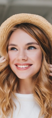 Woman in sunhat grinning