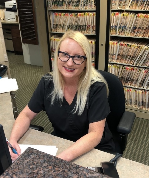 Lewisville dental team member sitting at desk