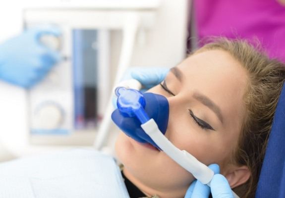 Patient receiving dentistry treatment with nitrous oxide dental sedation