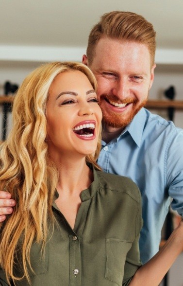 Man and woman smiling after receiving dental serivces in Lewisville, TX