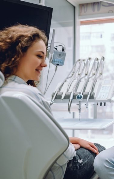 Woman talking to dentist about advanced dental services and technology