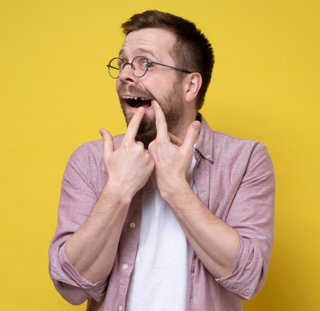 Man pointing to missing tooth
